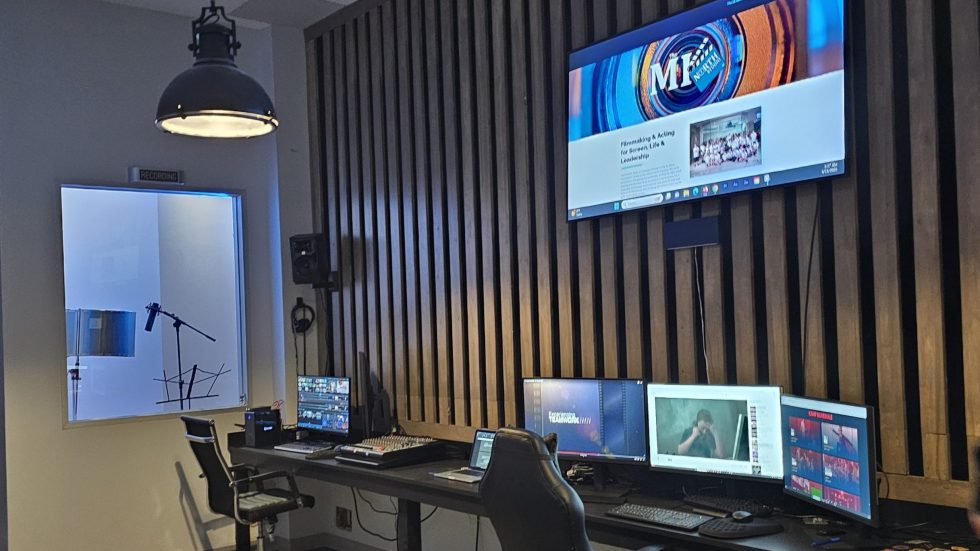 The MI North post-production suite with editing monitors and a voiceover booth